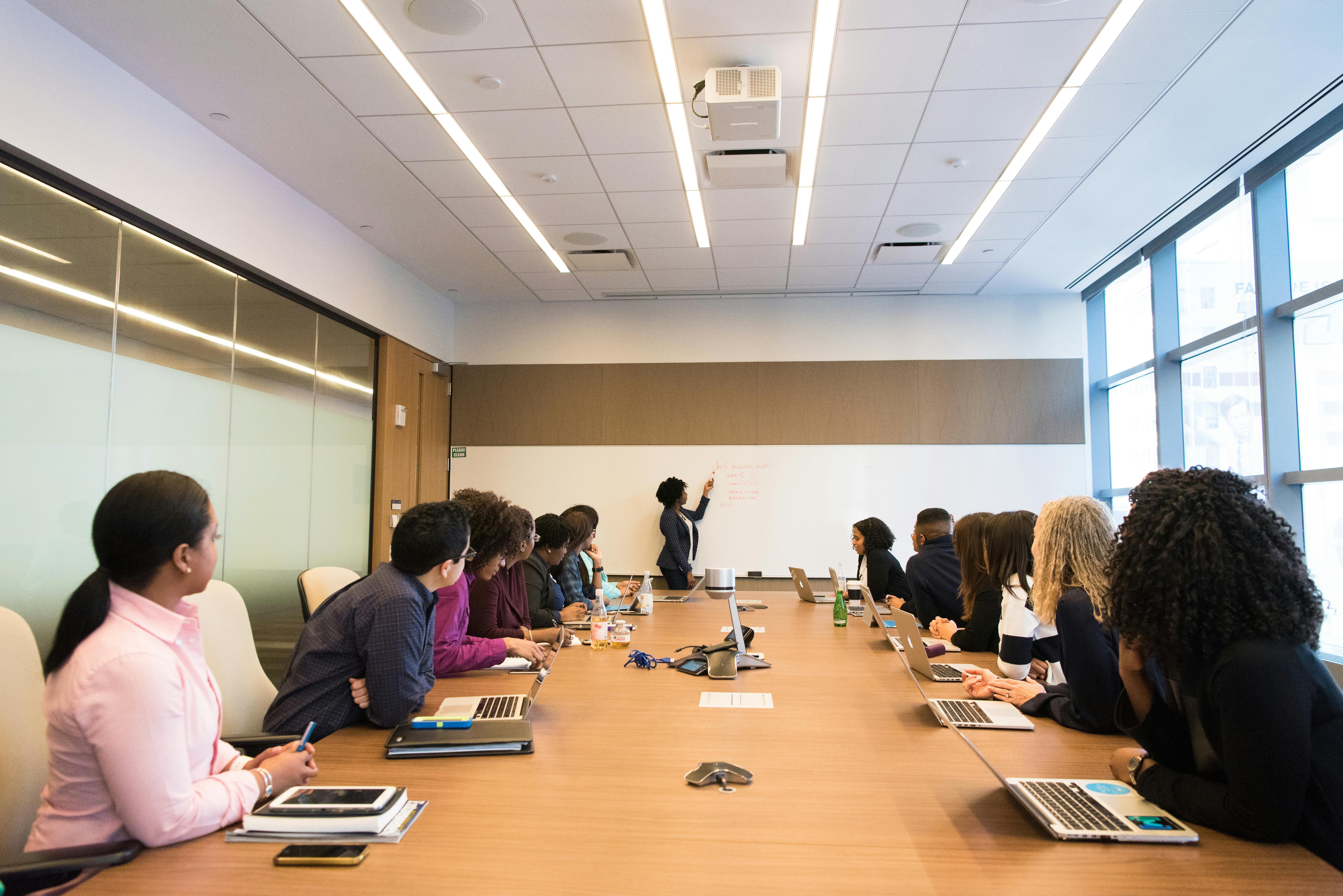 Residency training session with diverse medical professionals collaborating around a conference table